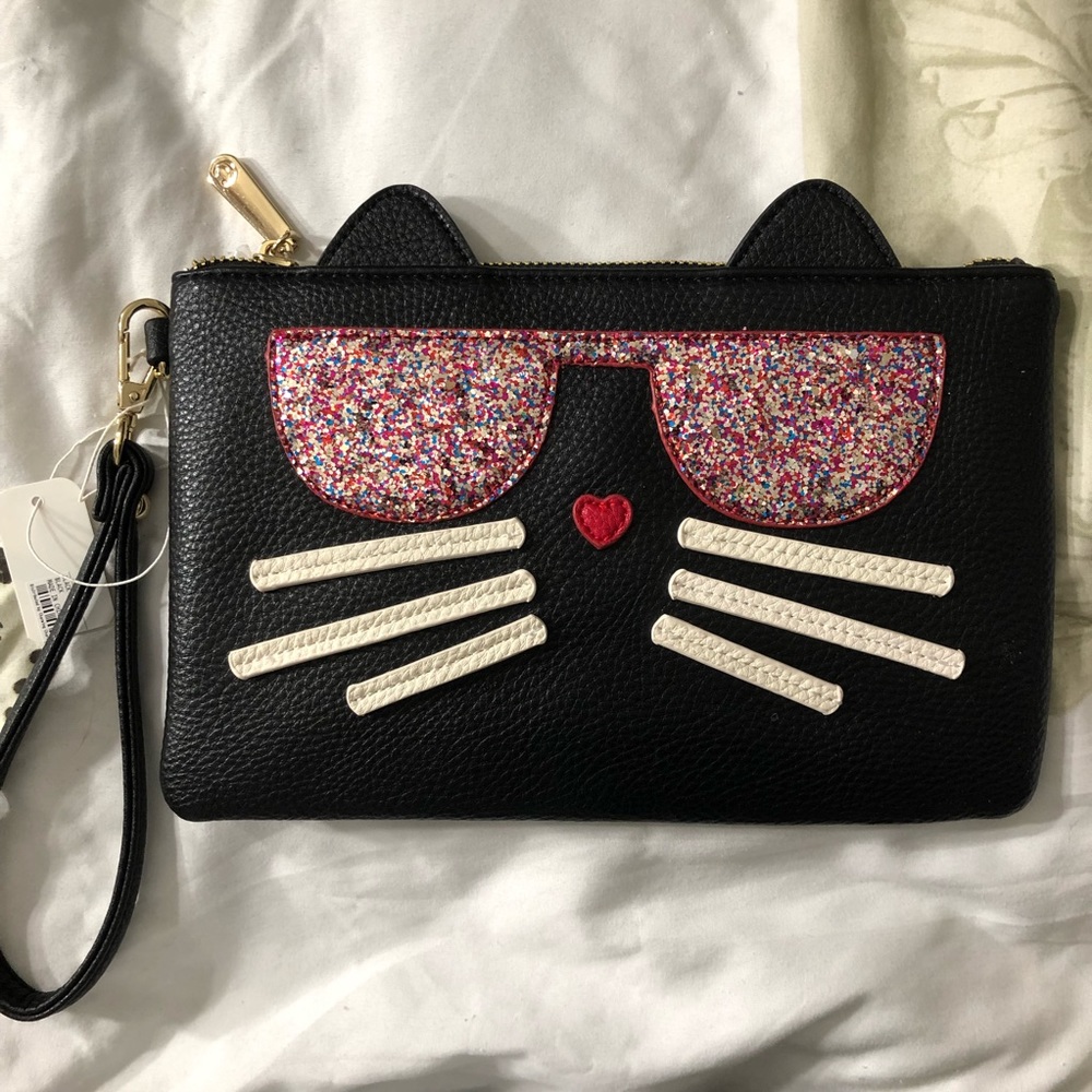 NWOT Cute Cat Wristlet. Big enough to hold several items. EXCELLENT condition.